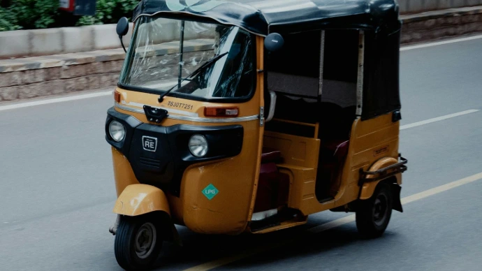 yellow and black auto rickshaw on road during daytime